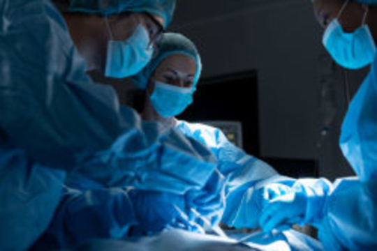 Diverse group of male and female surgeons in operating theatre