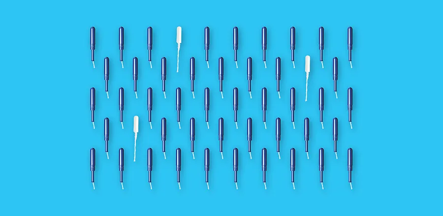 A group of tampons on a blue background.
