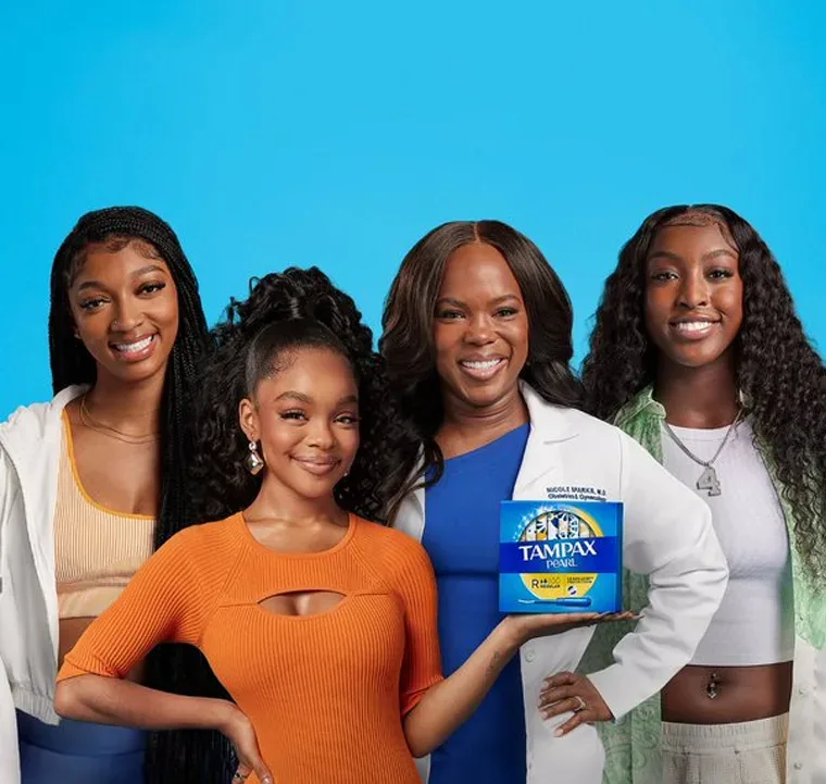 Four girls smiling with a Tampax Packshot
