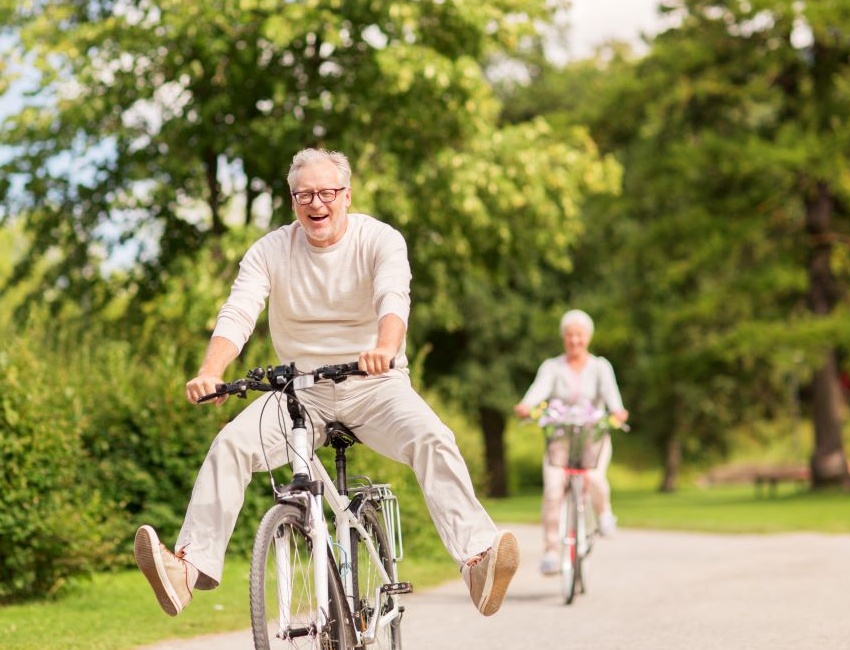 Old couple riding bikes together