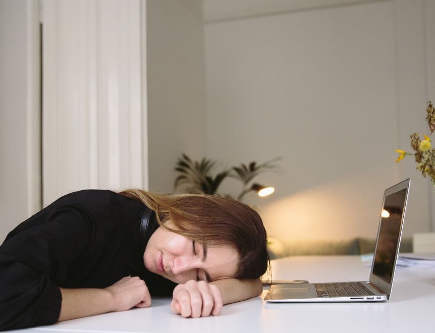 Woman having a nap while working