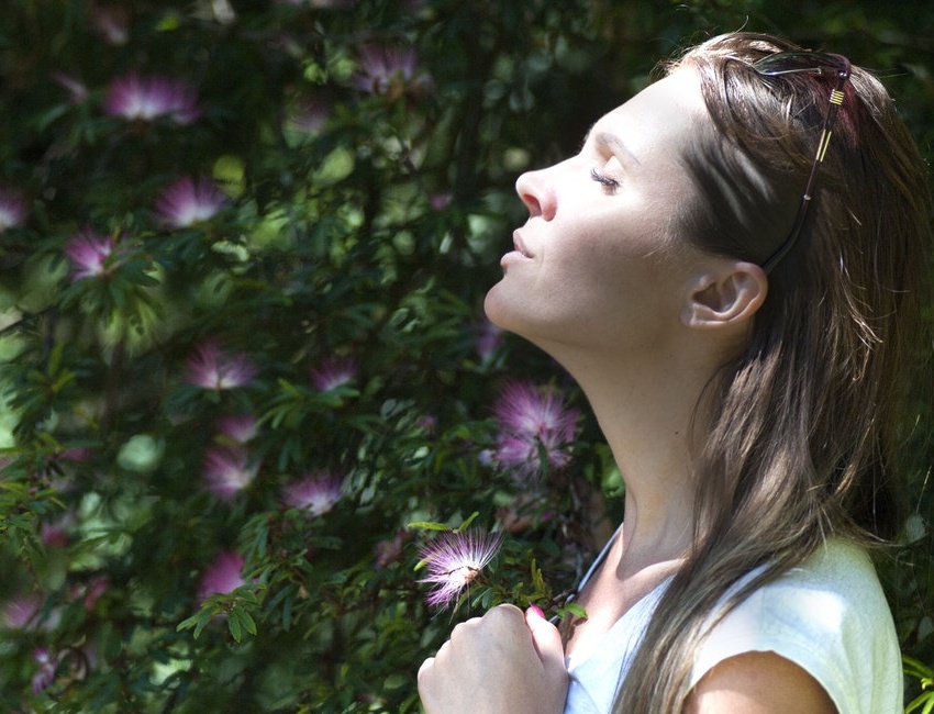 Woman breathing peacefully to reduce stress