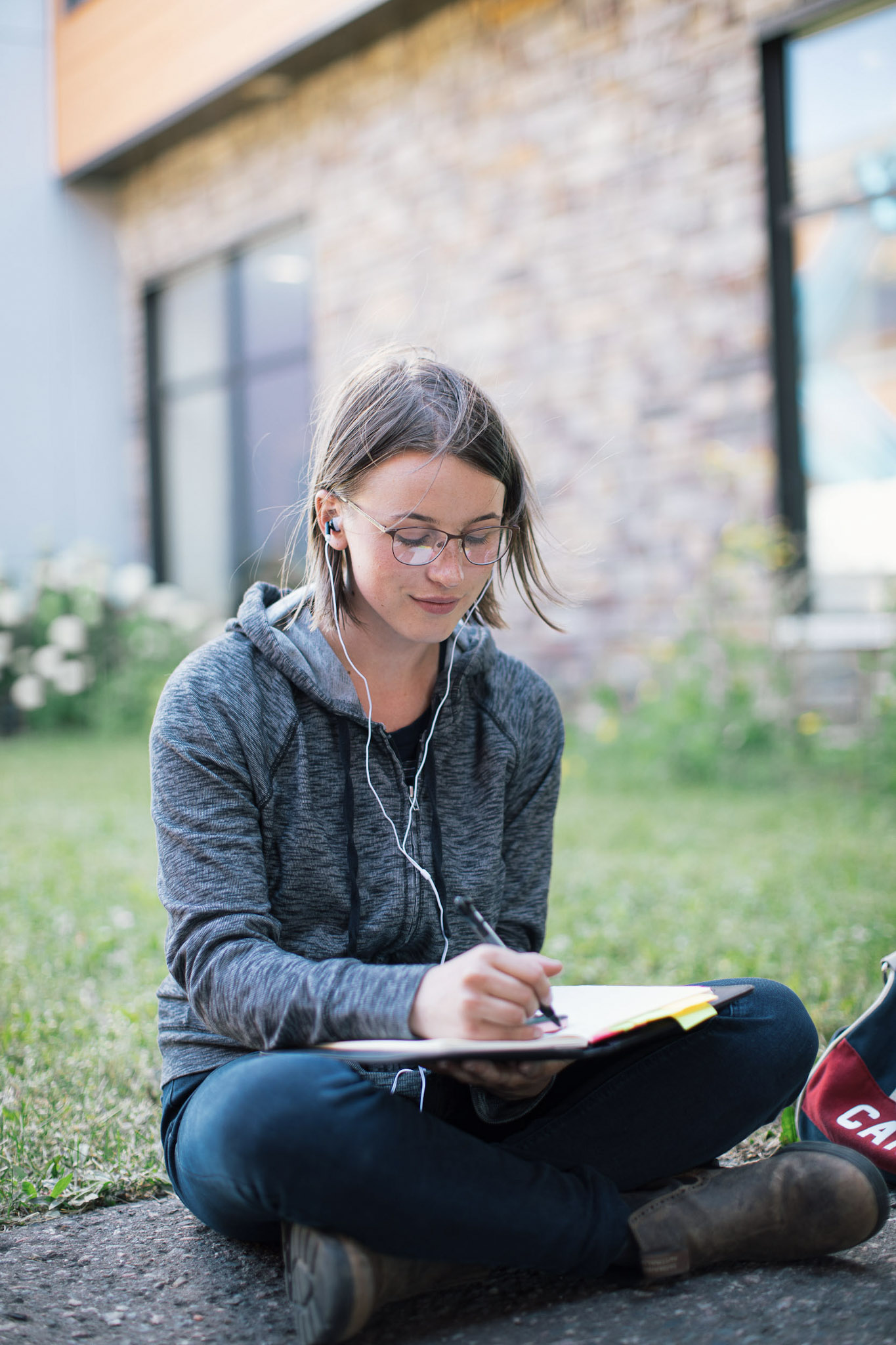 A student takes notes in a notebook