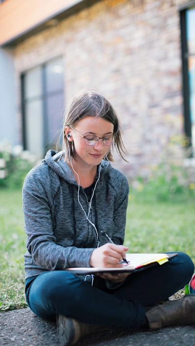 A student takes notes in a notebook