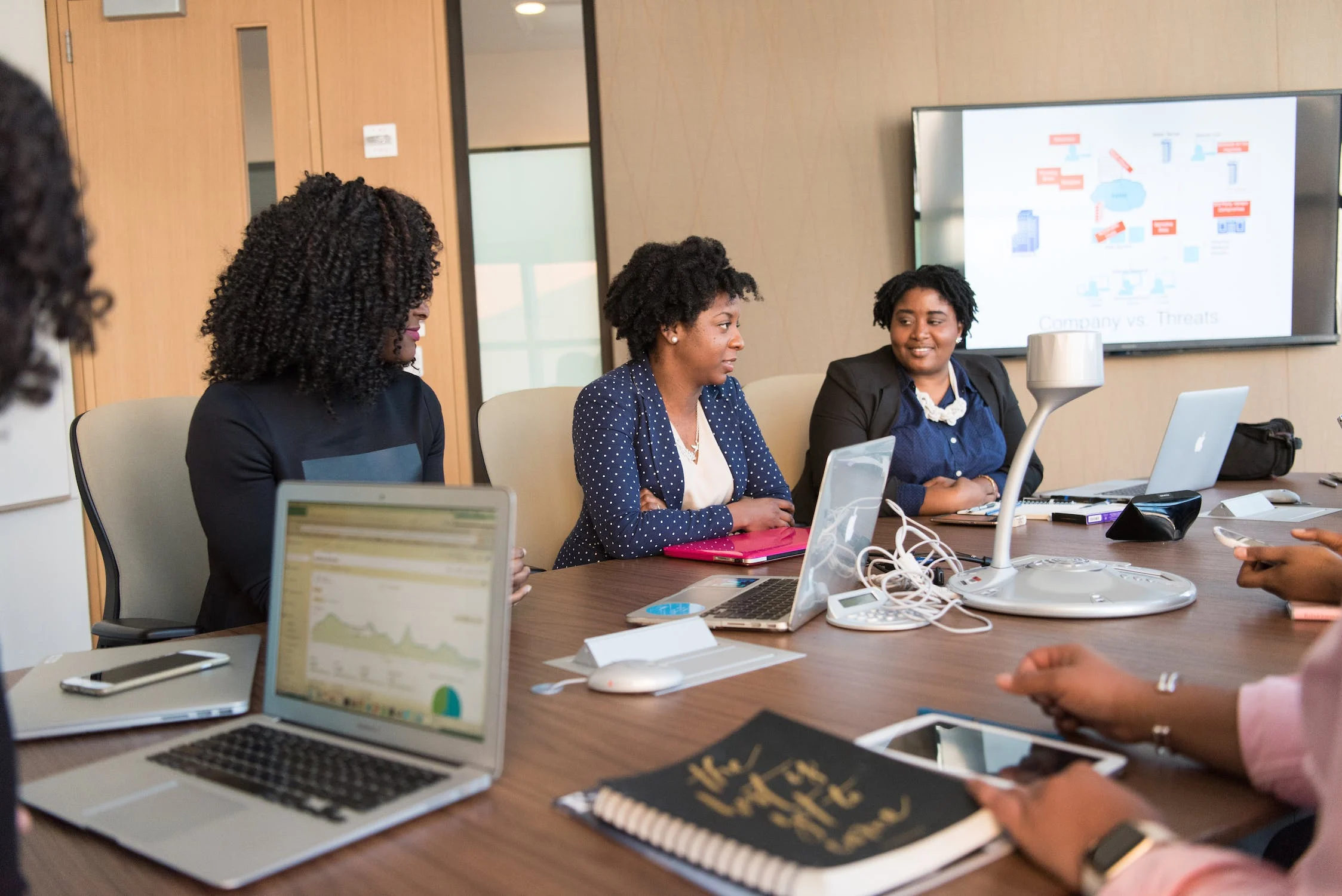 students in a collaborative boardroom setting