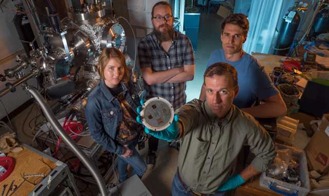 Engineers holding component