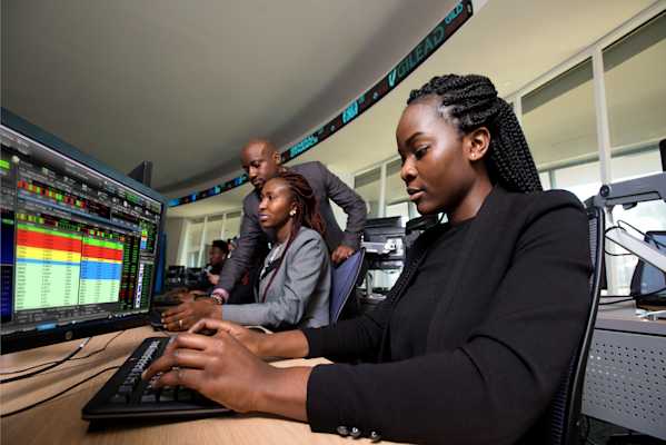Students and Professor working in a computer lab setting