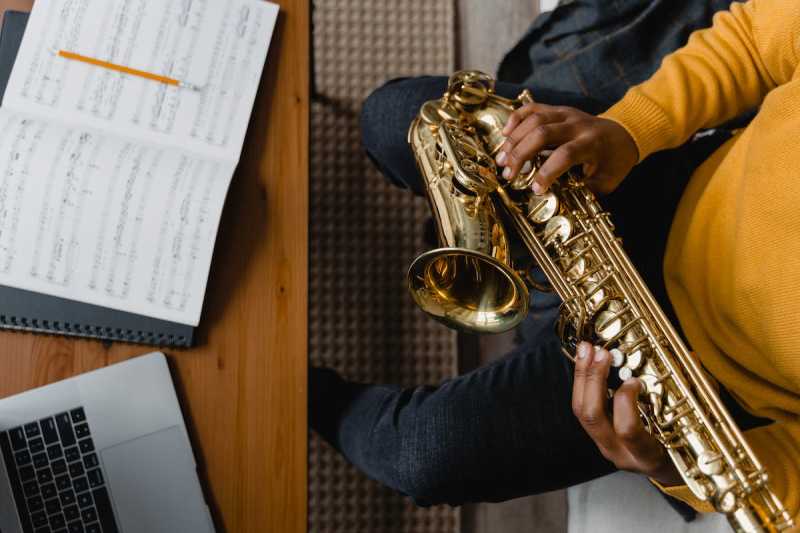 Student Holding a Saxophone