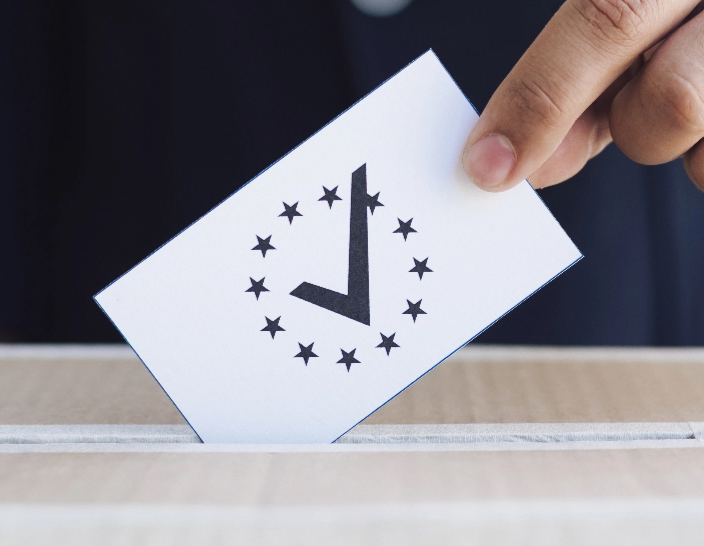 man putting ballot box close up