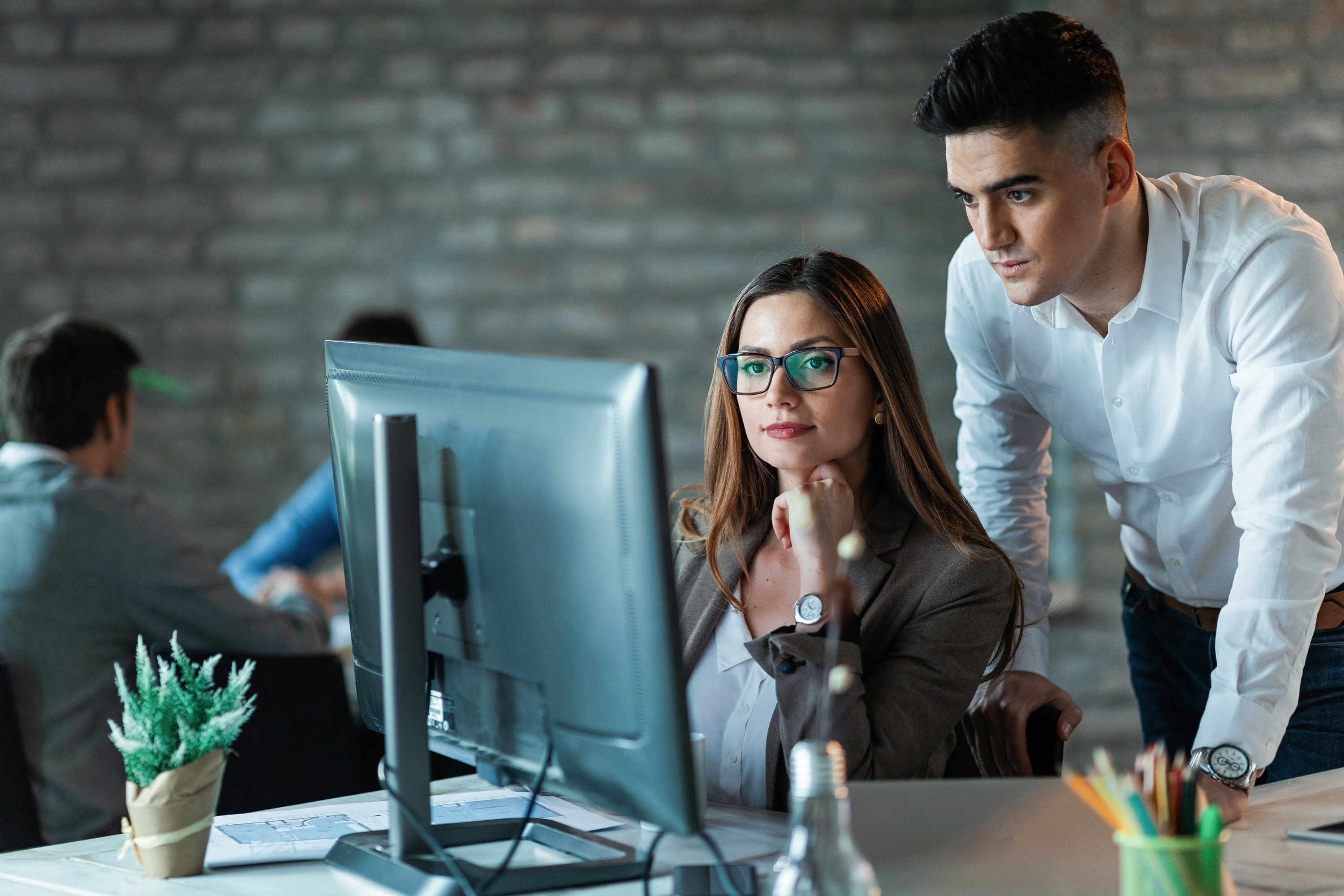 two-young-entrepreneurs-working-computer-reading-email-office2