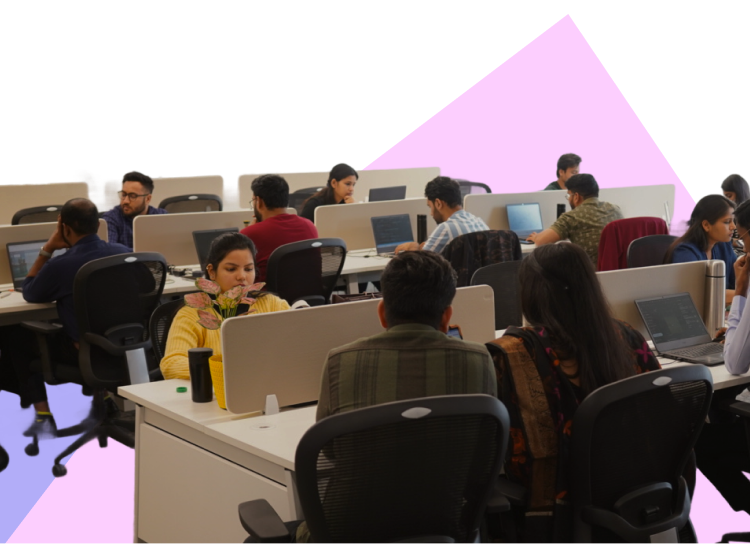 Digitup team working in an open office under a banner about work-life balance and collaboration