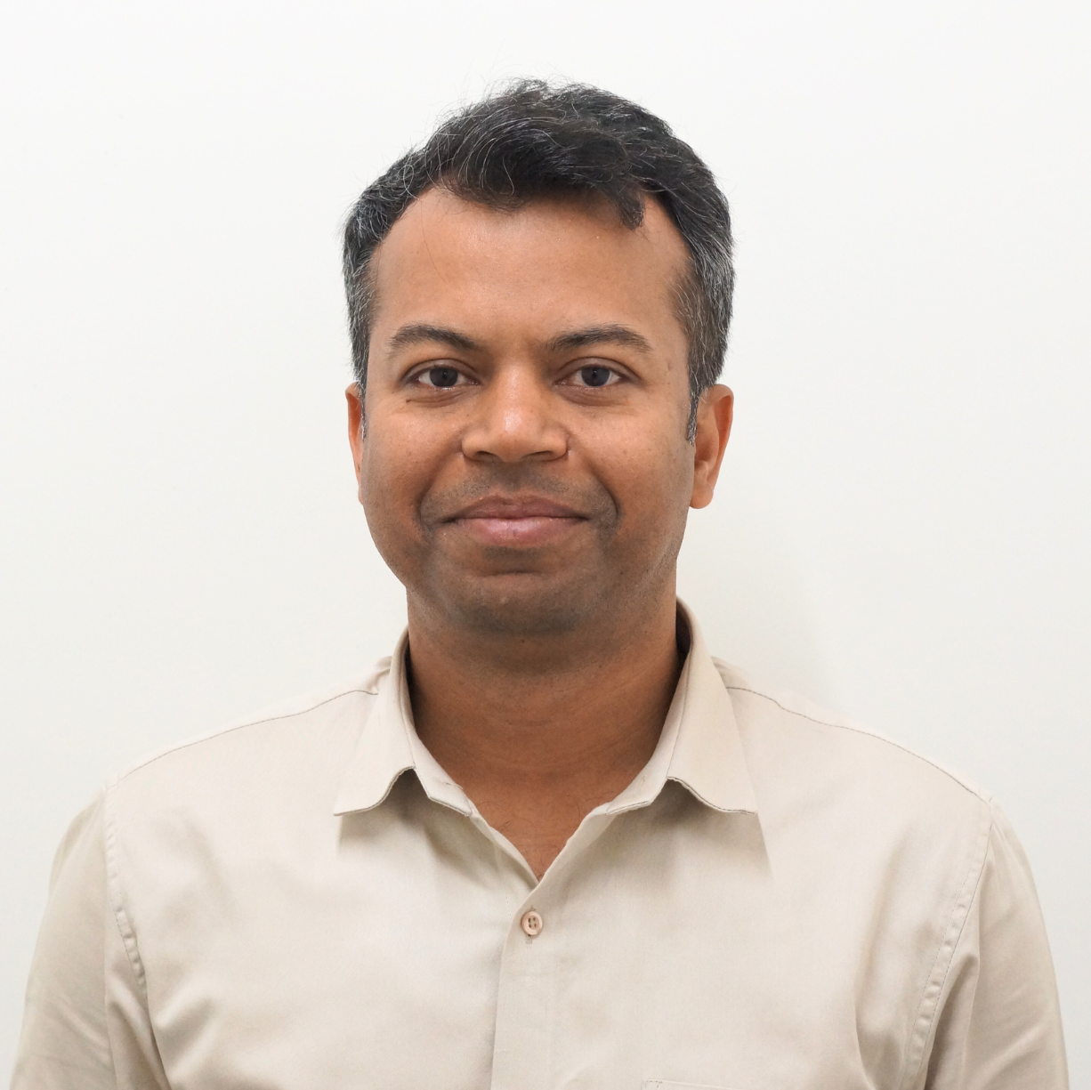 Amit Verma, CEO of Digitup, smiling in a formal light-colored shirt against a plain background