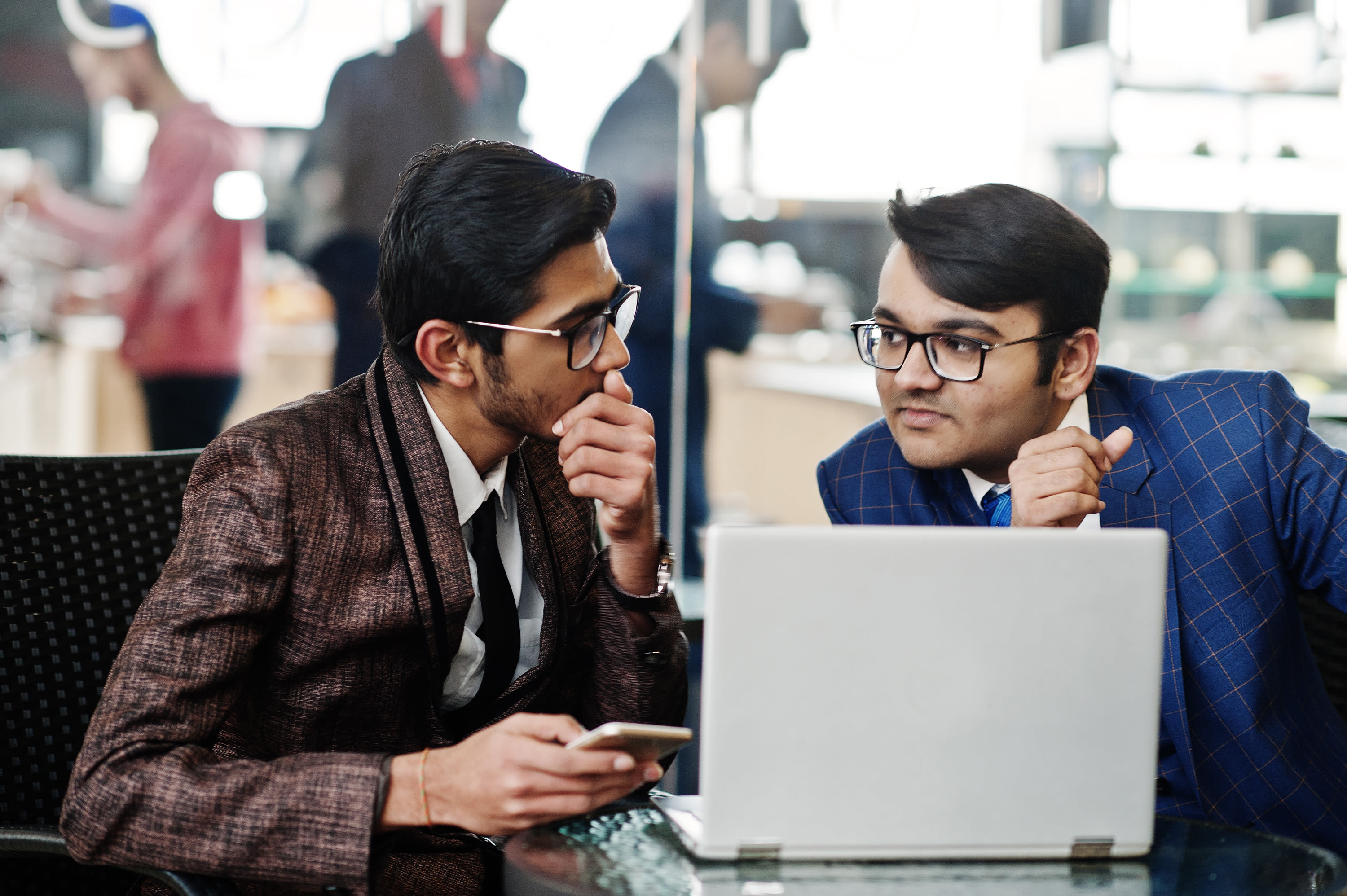 two-indian-business-man-suits-sitting-office-cafe-looking-laptop2