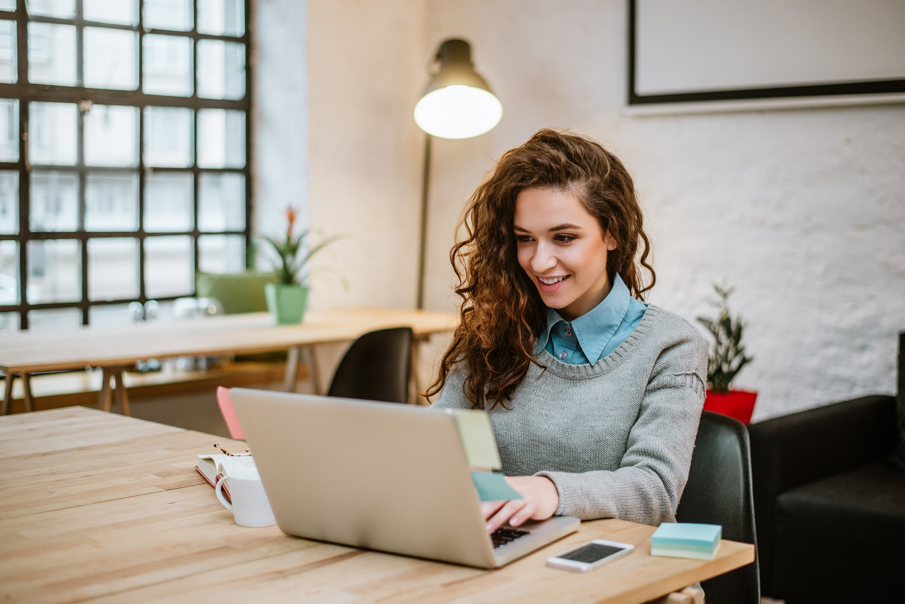 successful-young-woman-modern-office-working-laptop2
