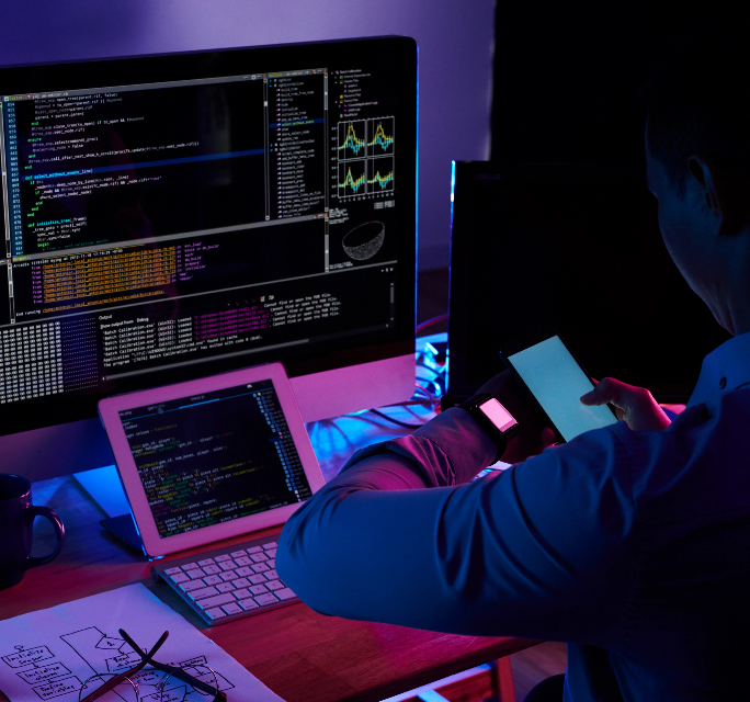 programmer-scanning-screen-his-smartwatch-with-smartphone-camera@2x