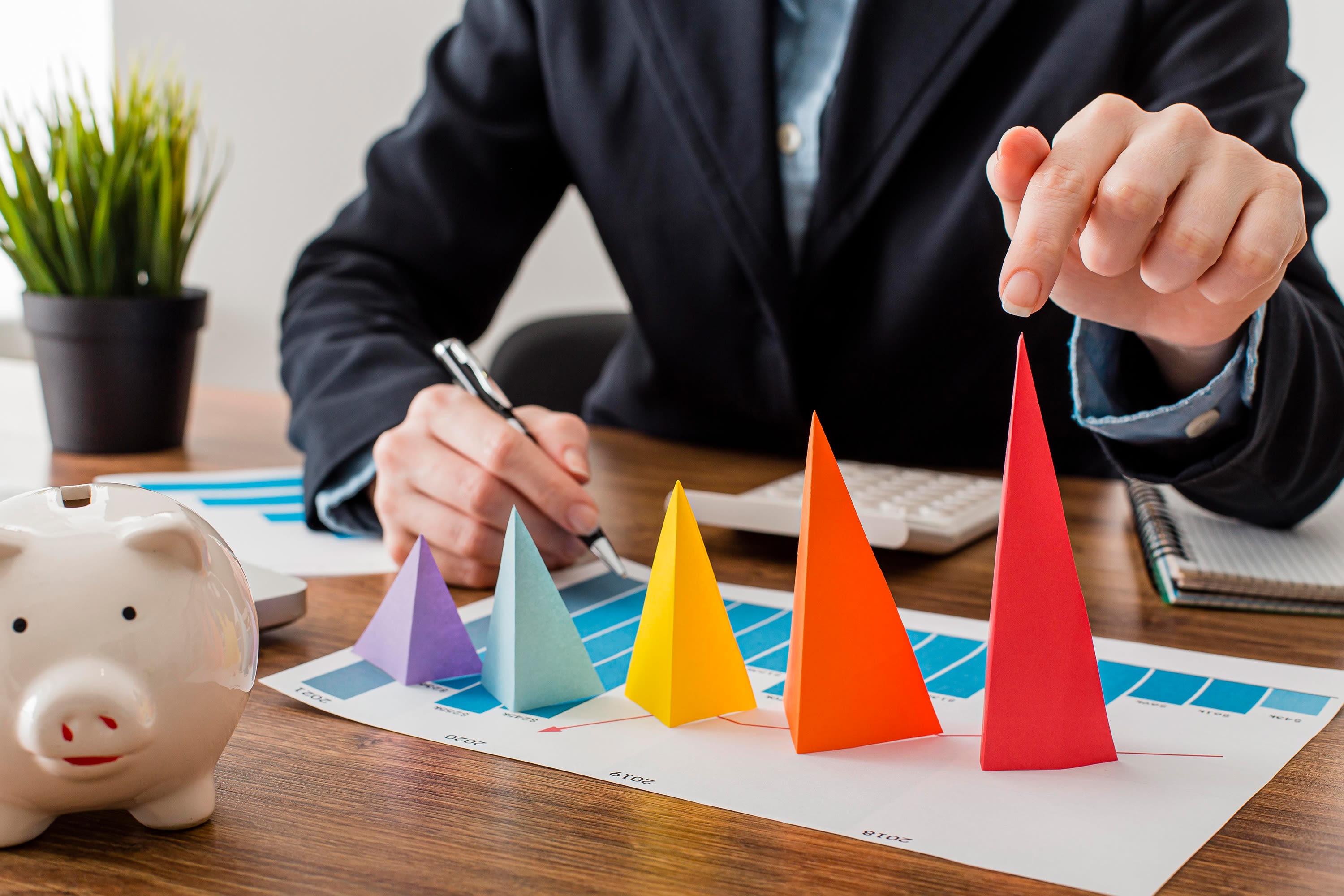 front-view-businessman-with-colorful-cones-representing-growth2
