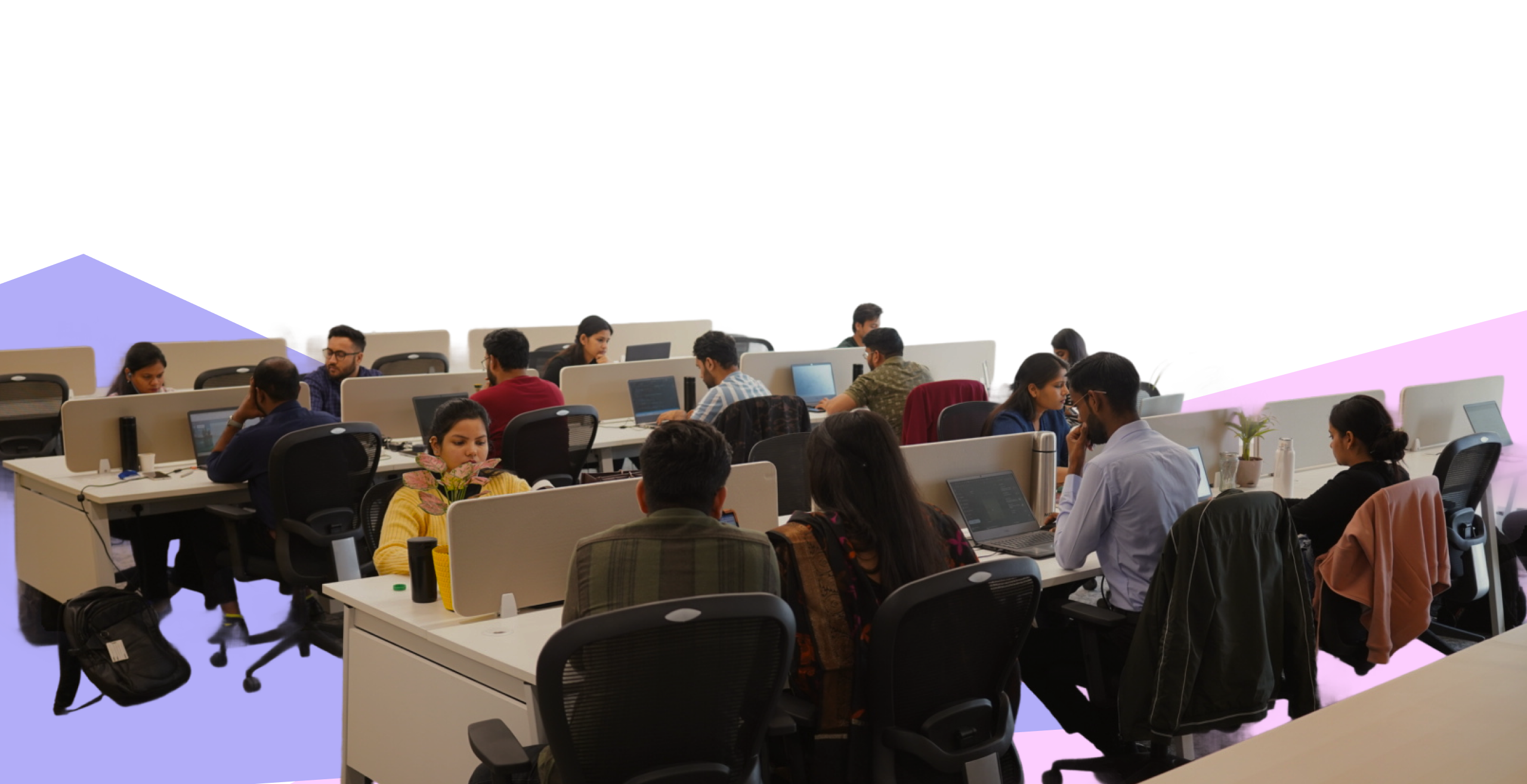 Digitup team working in an open office under a banner about work-life balance and collaboration