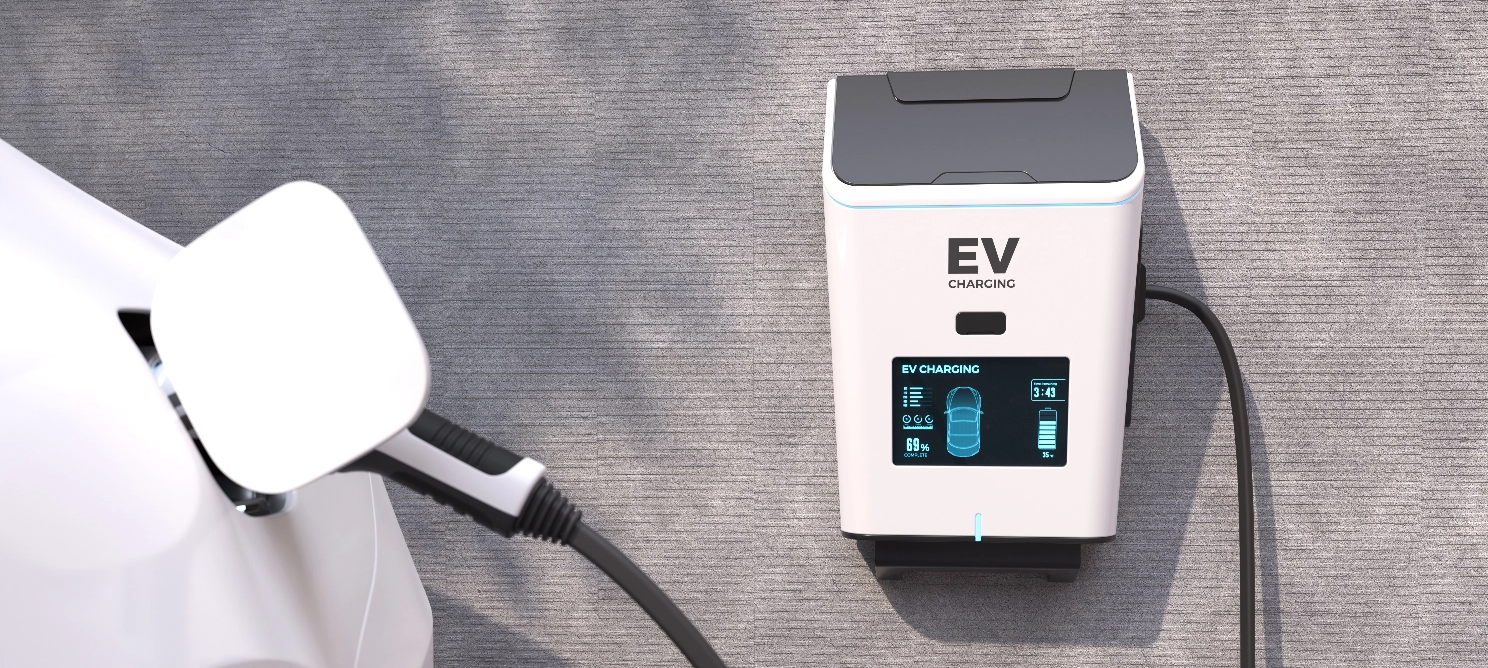 Electric vehicle connected to a wall-mounted EV charging station, illustrating battery-driven electric vehicle charging