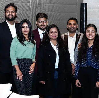 Digitup employees posing together in formal attire at an event