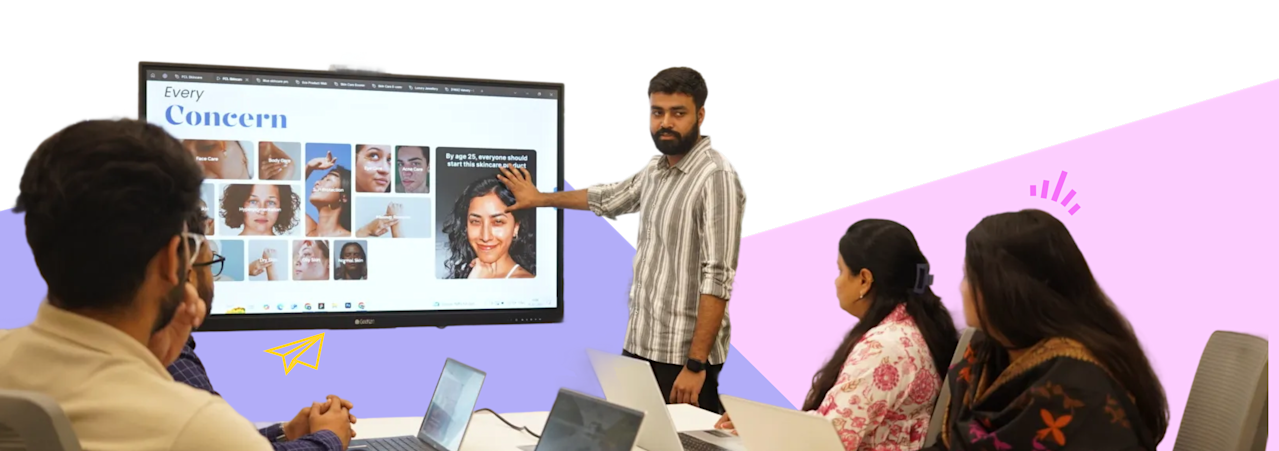 Digitup team in a meeting room discussing ideas with a screen presentation, reflecting their core values of trust, transparency, and collaboration