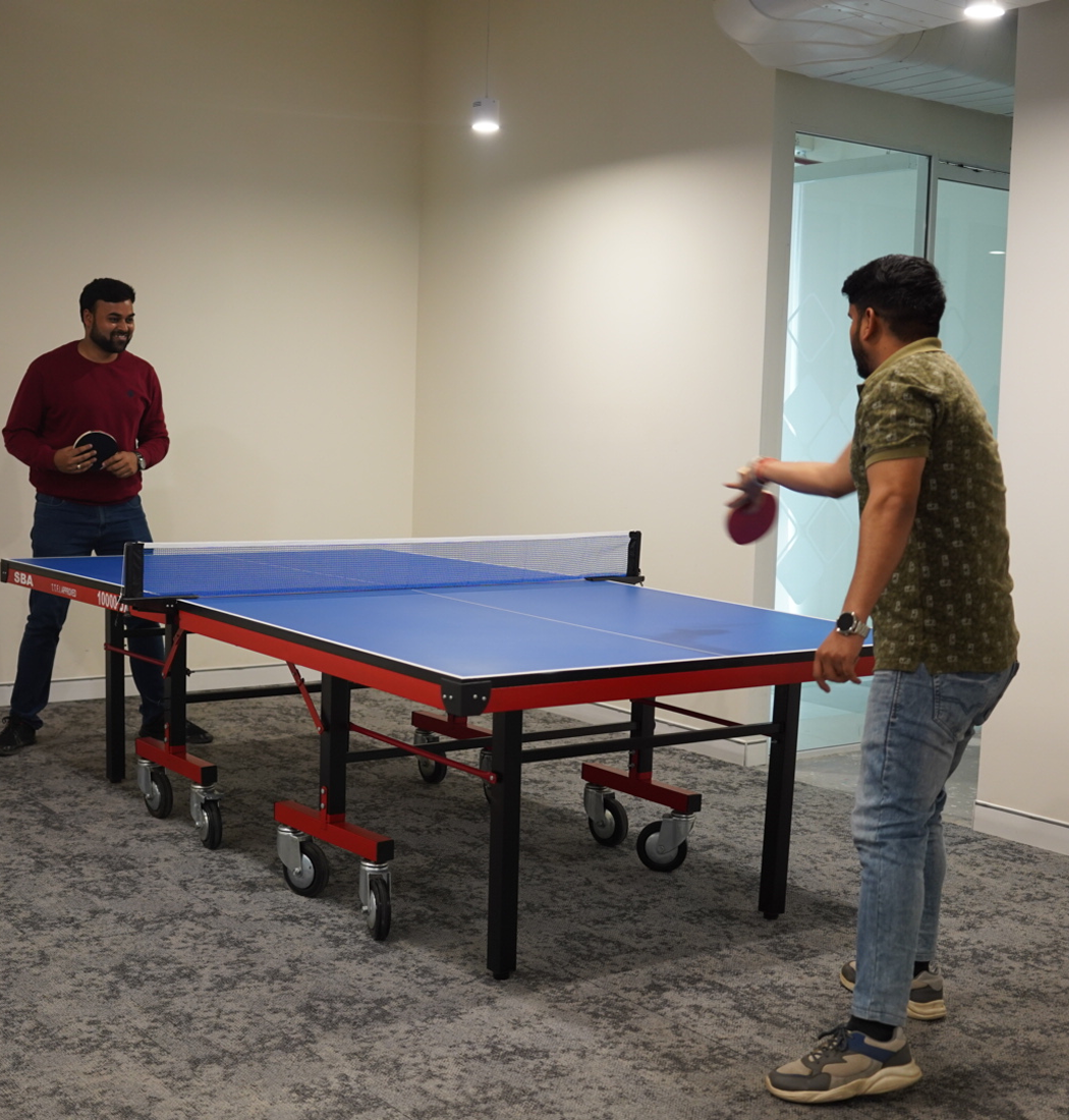 Digitup team members playing table tennis as part of their work-life balance initiative