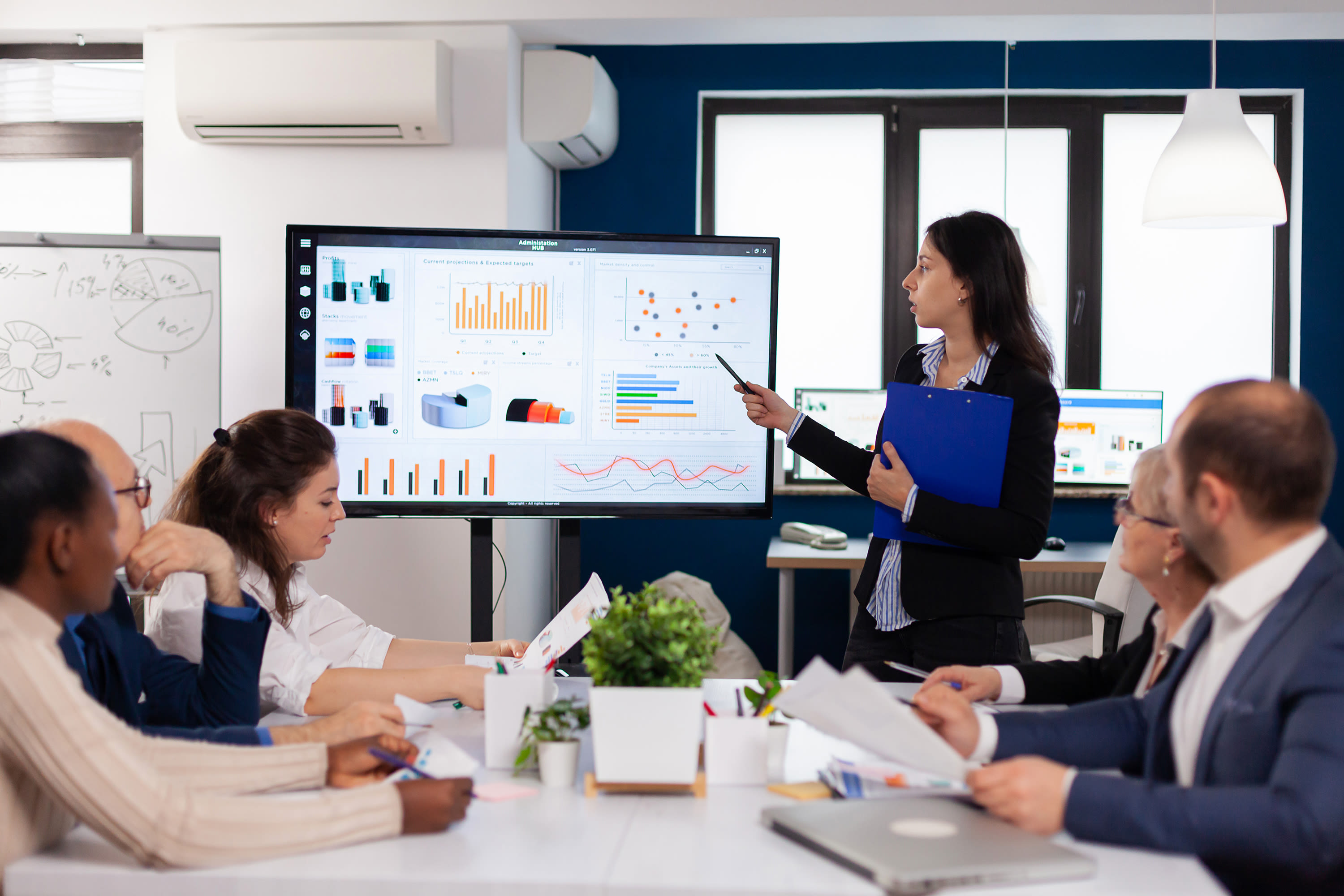 young-team-leader-big-corporation-briefing-coworkers-pointing-graph-meeting-corporate-staff2