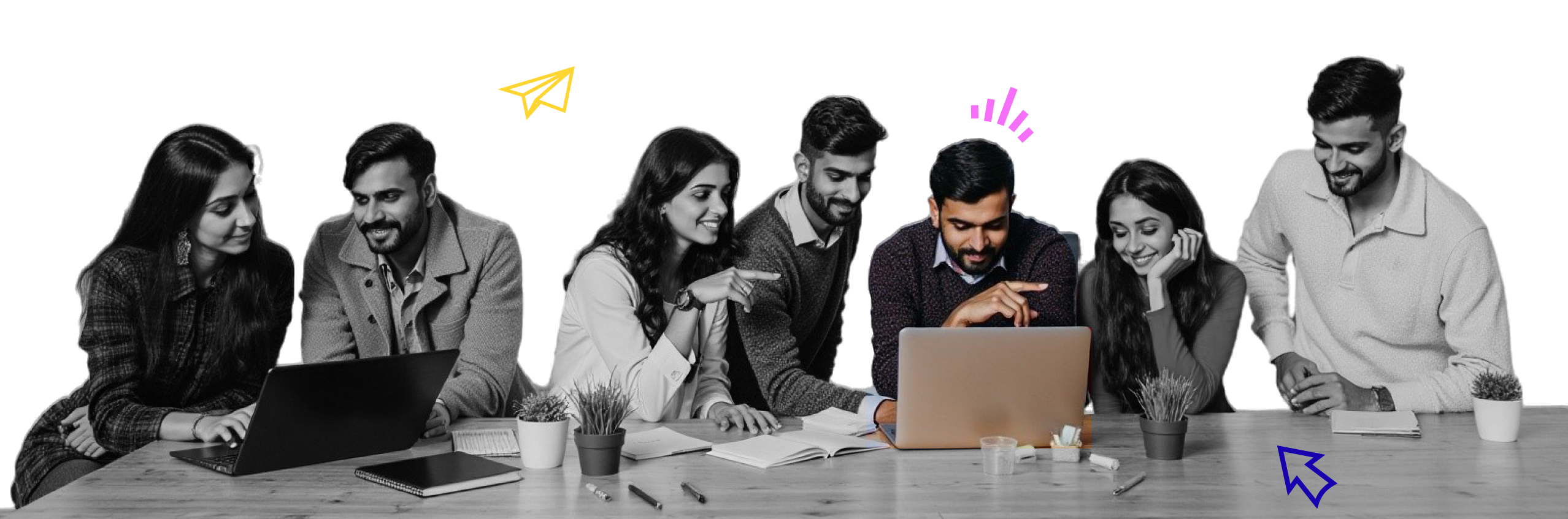 young professionals collaborating at a desk with laptops and notebooks, representing talent growth and teamwork