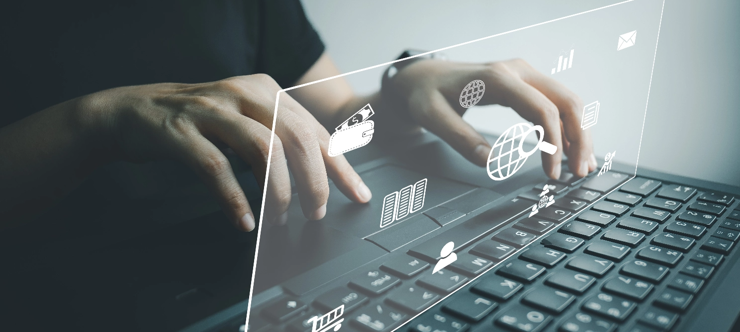 Hands typing on a laptop keyboard with digital overlay icons of SEO elements like globe, bar graphs, search magnifier, and email—representing modern local SEO trends
