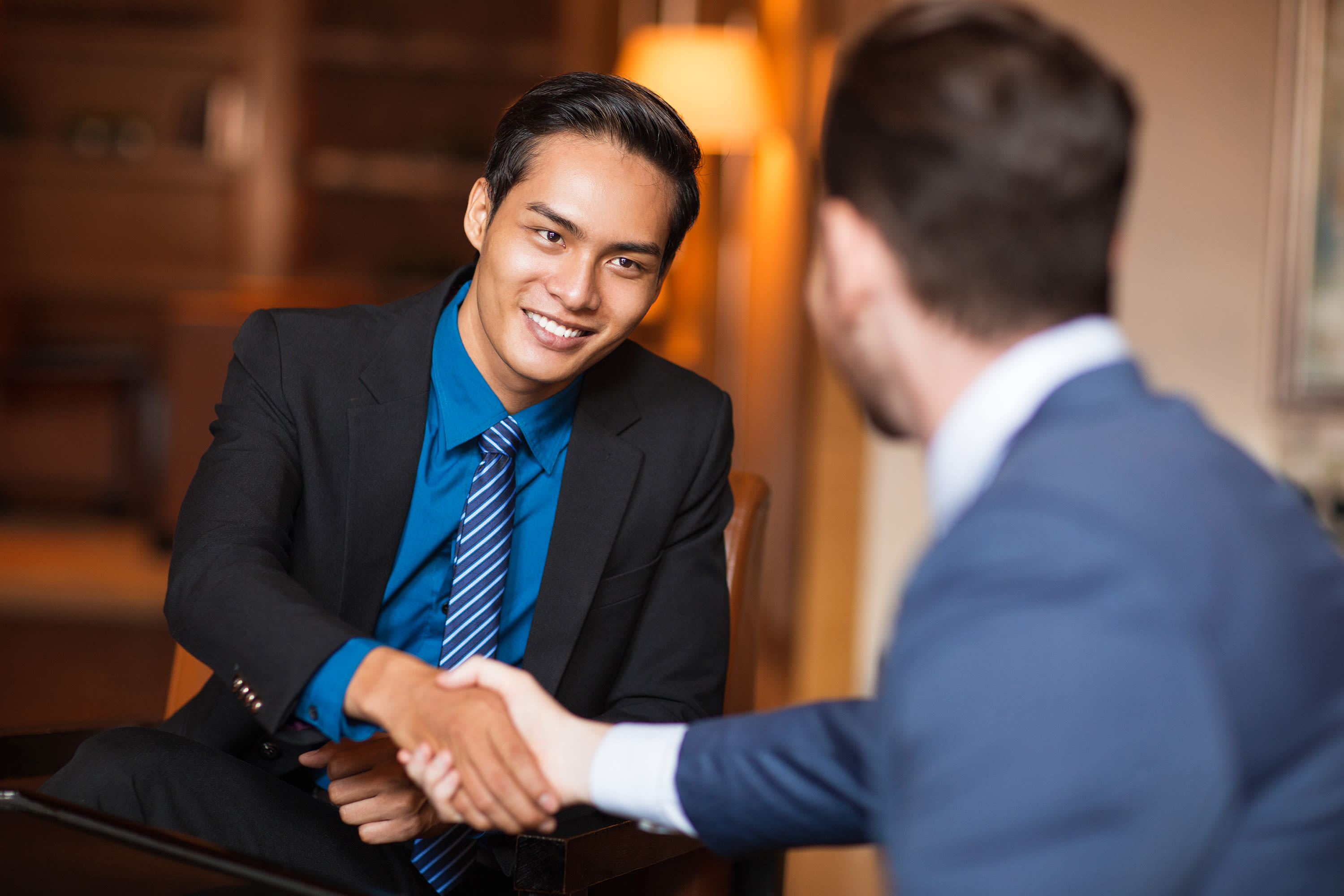 two-smiling-business-partners-shaking-hands2