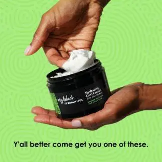 Hands holding Hydrating Curl Cream infused with coconut milk