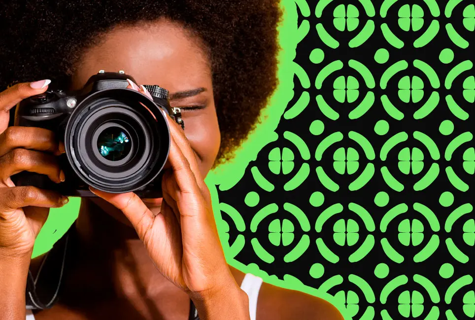 Black woman taking a photo with a camera
