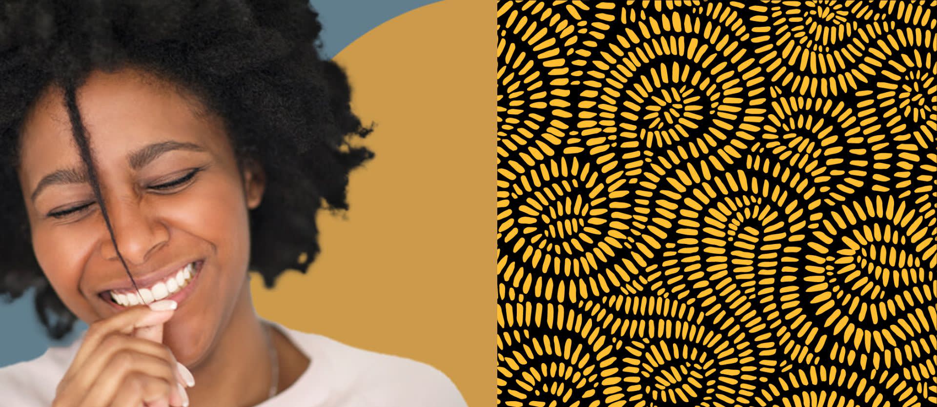 Black woman smiling and holding naturally curly hair