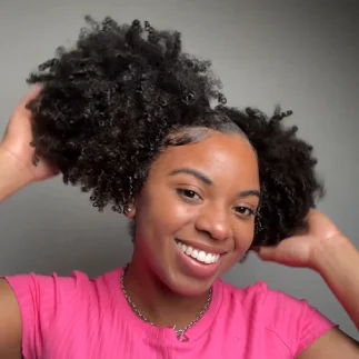 Black Woman smiling with two ponytails