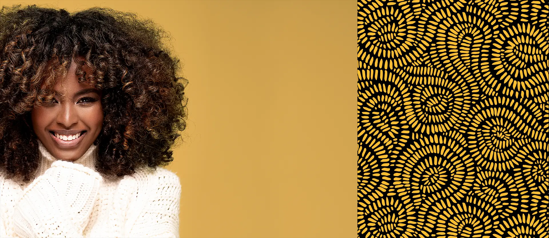 Black woman with coily moisturized hair in cream top smiling with her eyes closed, hands on her shoulders and head dipped back against a tan background.