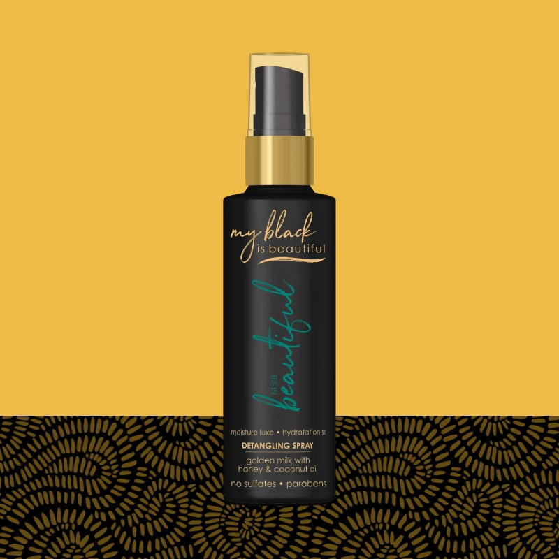 Golden Milk Luxe Detangling Spray bottle with pattern in the background