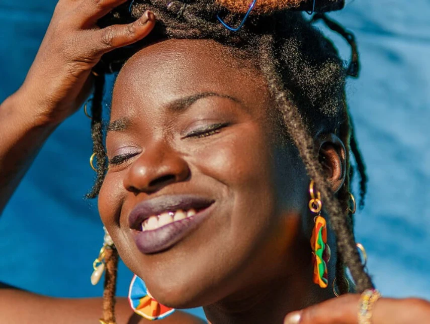 Black woman smiling with her eyes closed