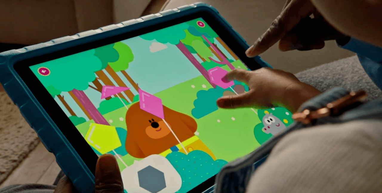 Child playing Go Explore game on tablet
