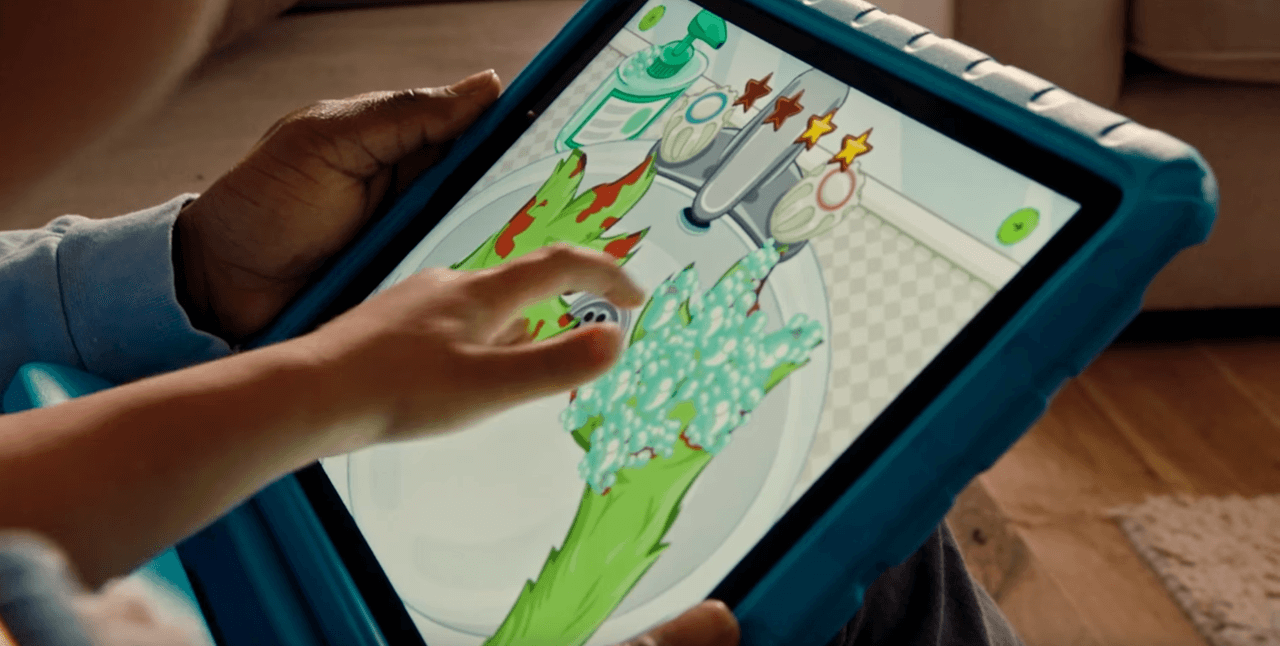 Child playing Go Explore game on tablet