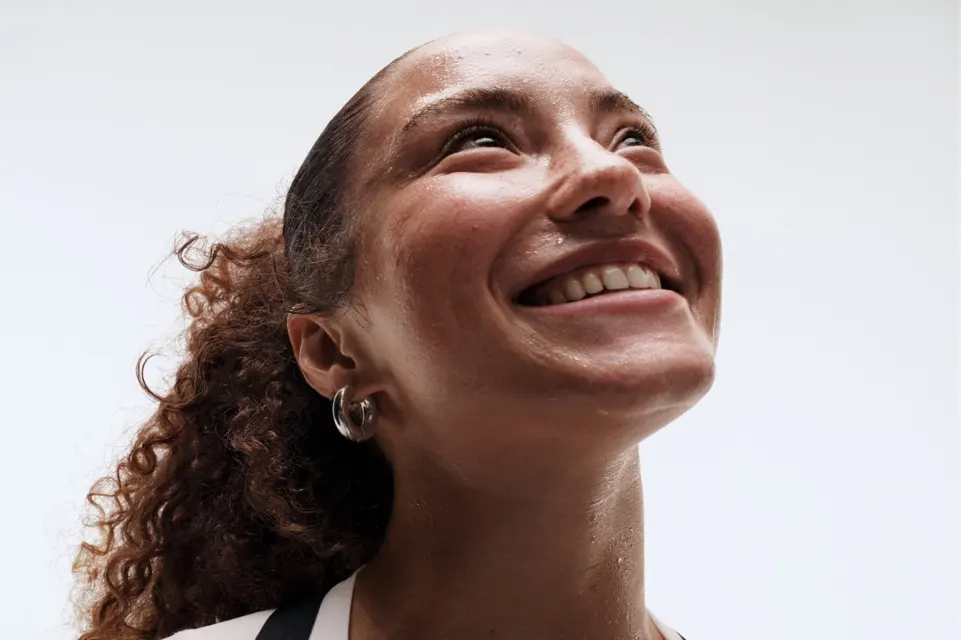 Close-up of a woman smiling after a workout.