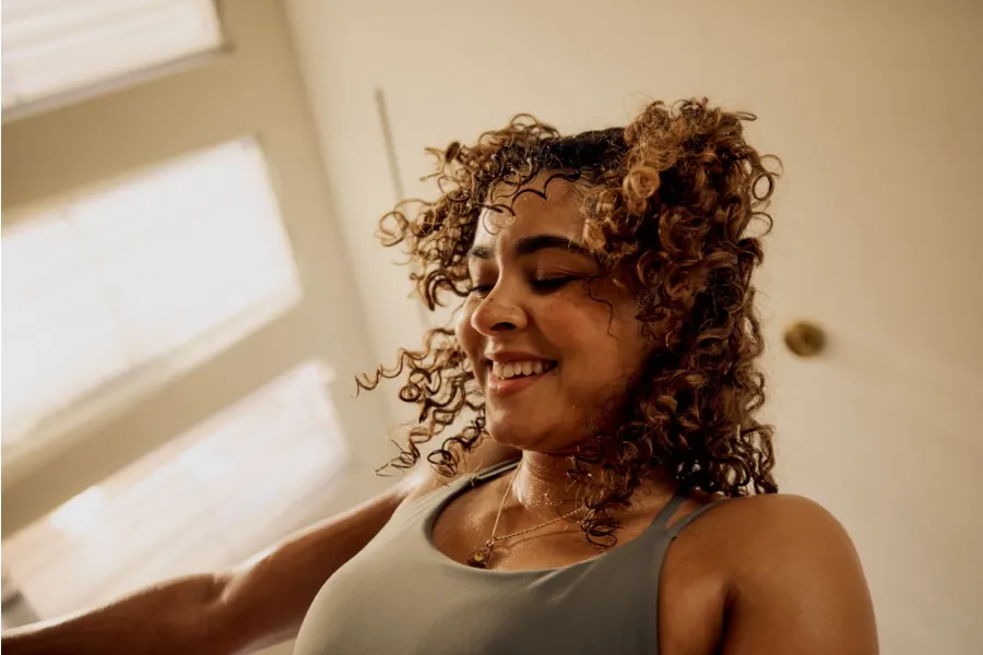 Close-up of a woman, sweaty but relieved, after a workout.