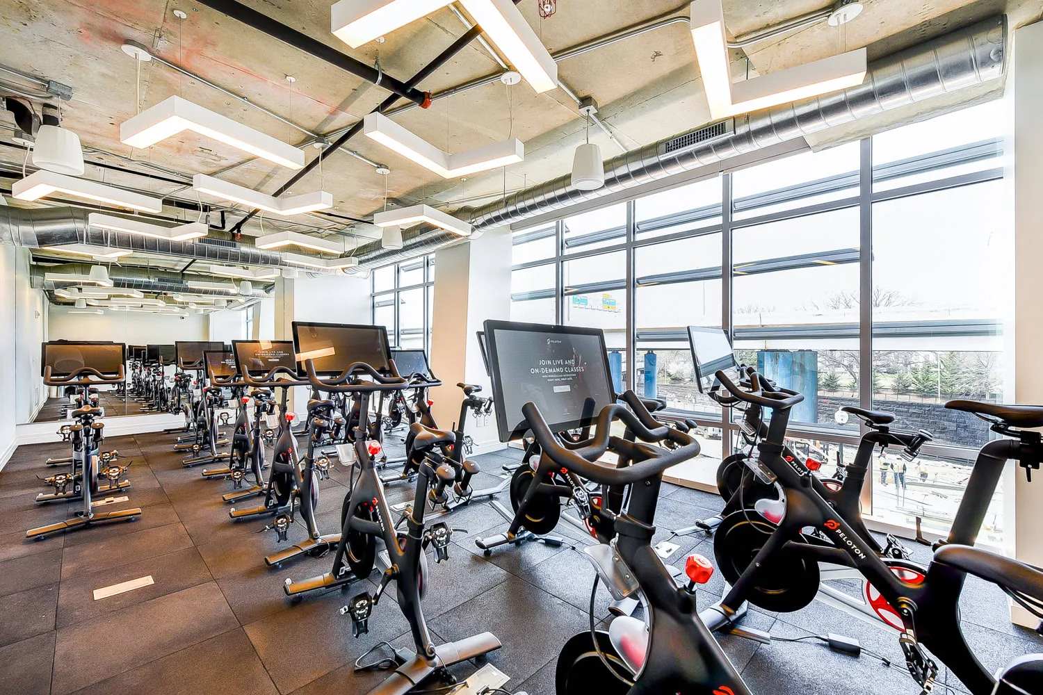 A room filled with Peloton Bikes as a multifamily residential fitness amenity at The Collective