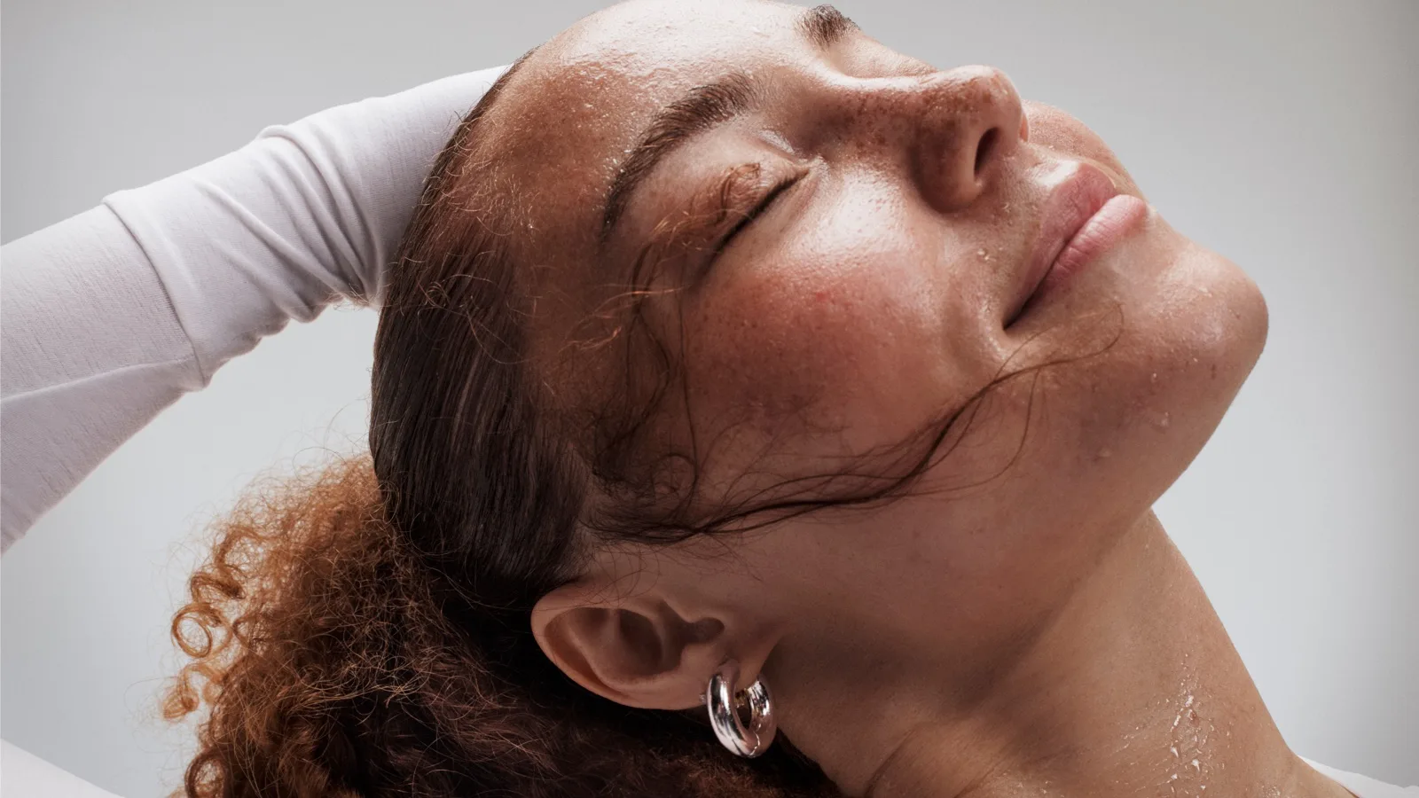 Close-up of a sweaty, but relieved woman's face after a workout.