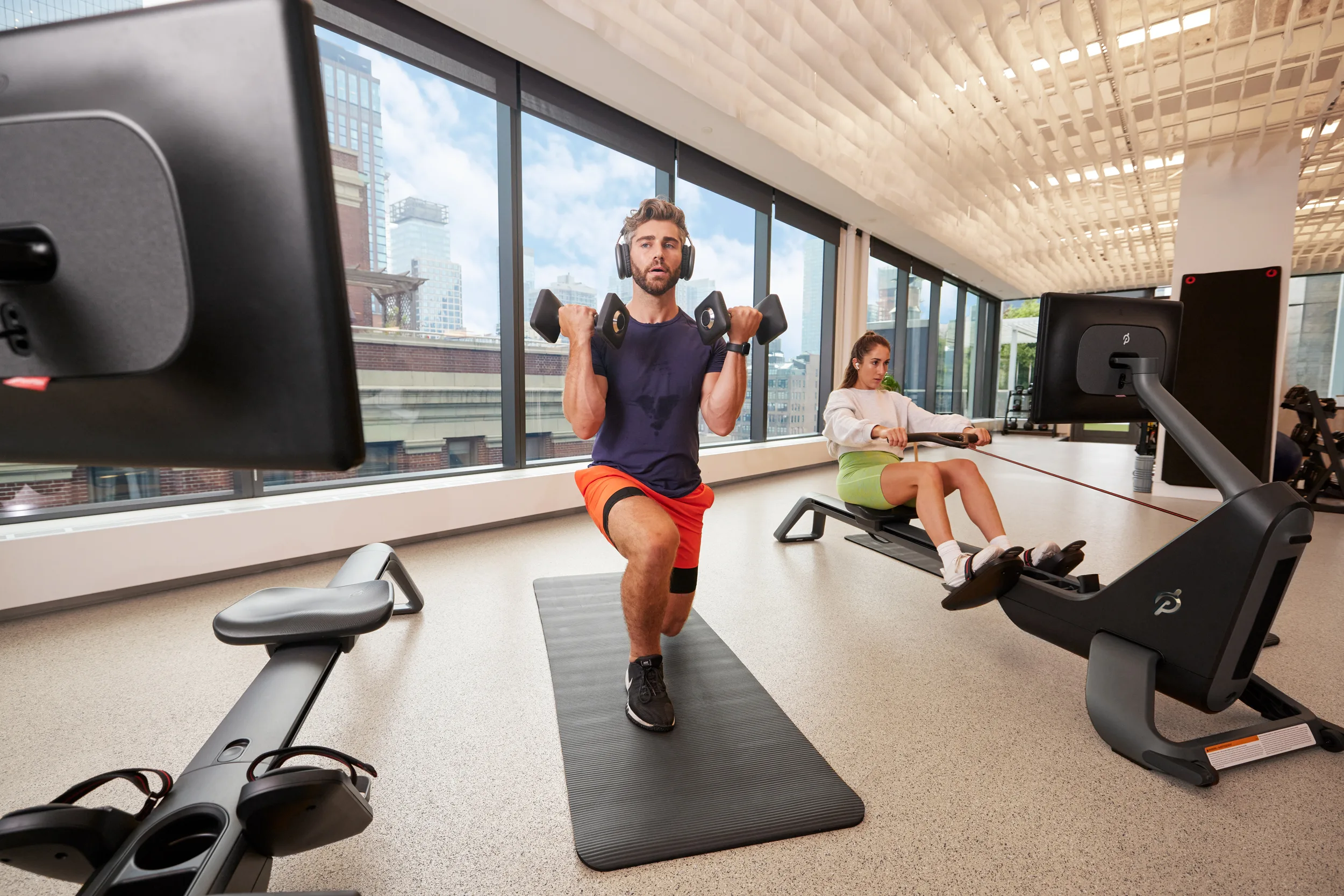 Peloton Members using the Peloton Row in a corporate gym