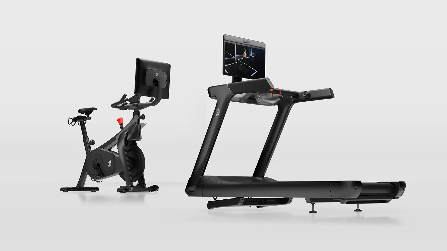 Peloton Commercial Bike and Peloton Commercial Tread placed side by side, angled slightly toward each other