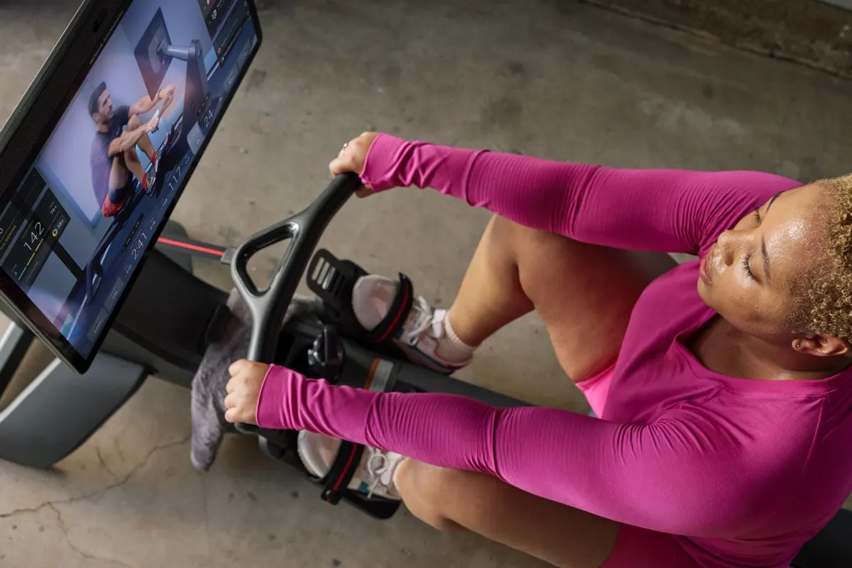 A female exerciser using the Peloton Row equipment