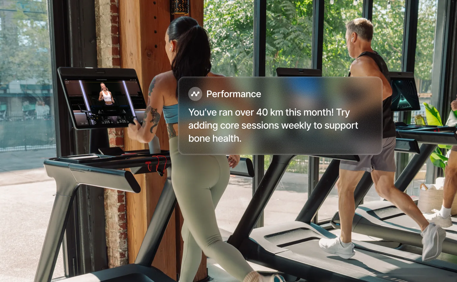 Two exercisers running on the Commercial Tread in a gym
