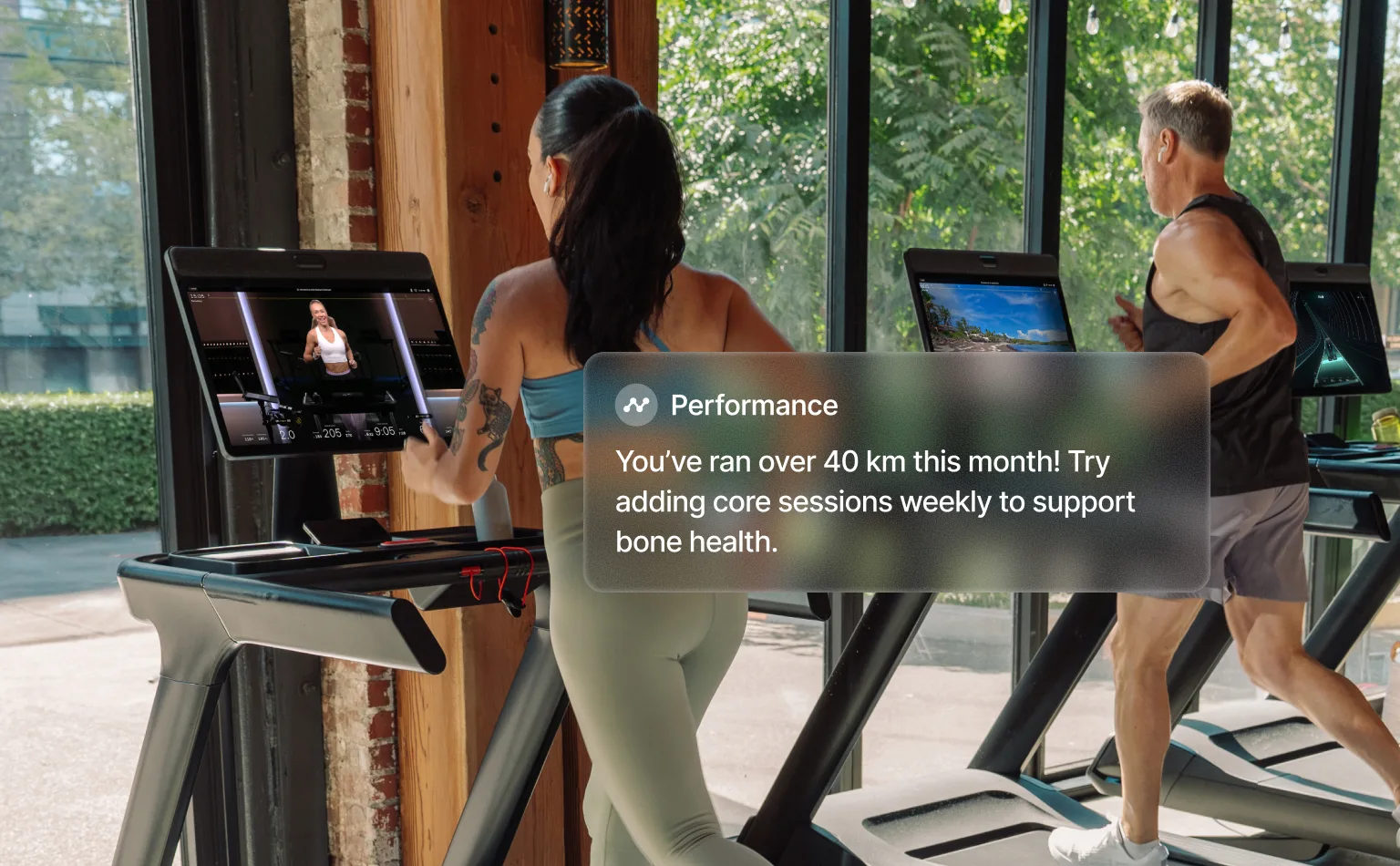 Two exercisers running on the Commercial Tread in a gym