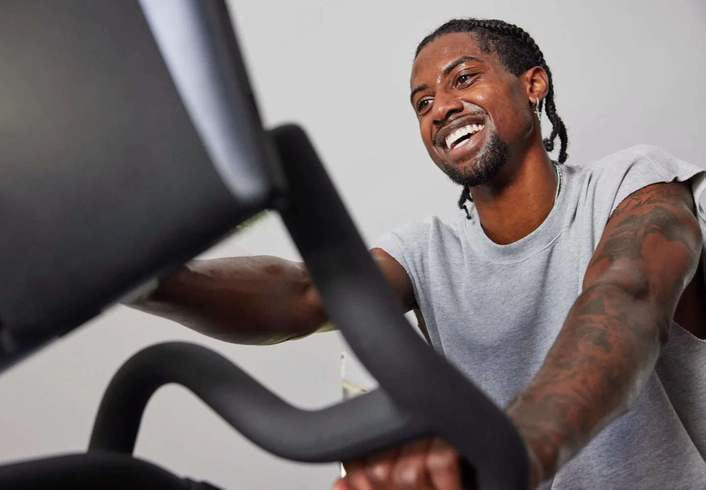 A male exerciser taking a cycling class on a Peloton Bike+ Pro