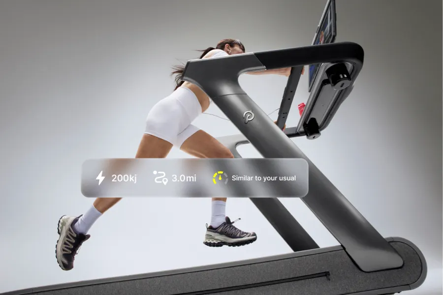 A person on Tread+ Pro running. An overlay shows their stats like output, miles run, and energy.