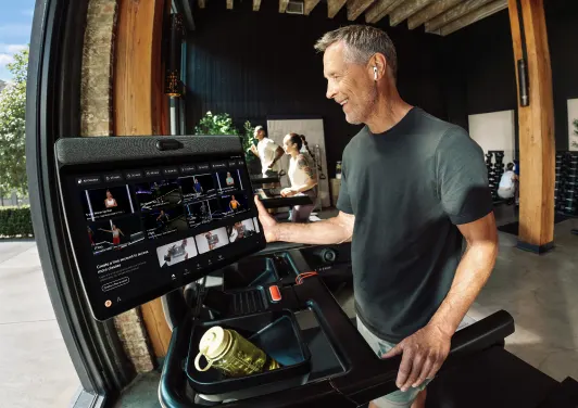 An exerciser selecting a class on a Peloton Commercial Tread